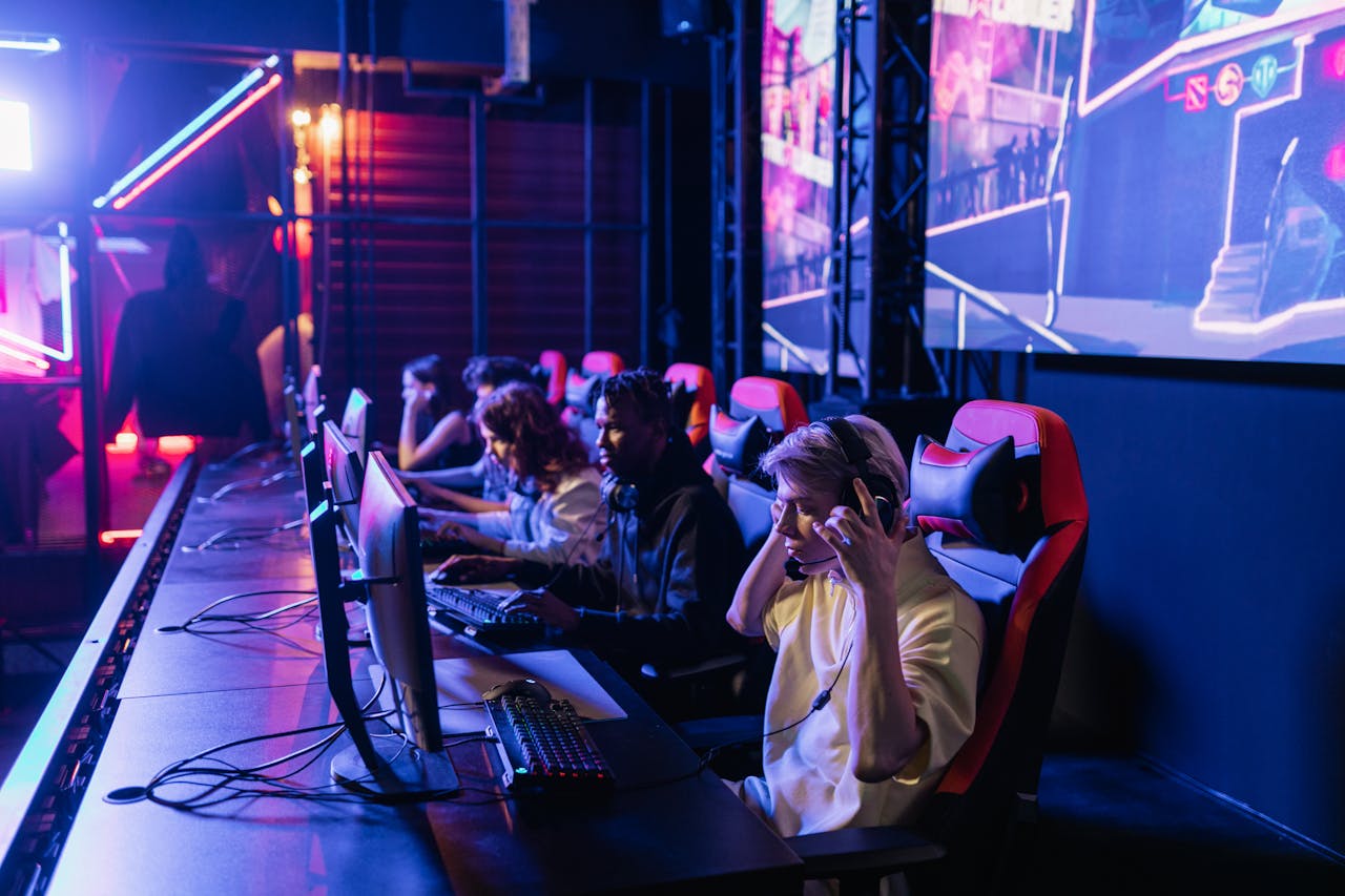 Home Focused gamers in a high-tech arena compete intensely, showcasing esports fervor.