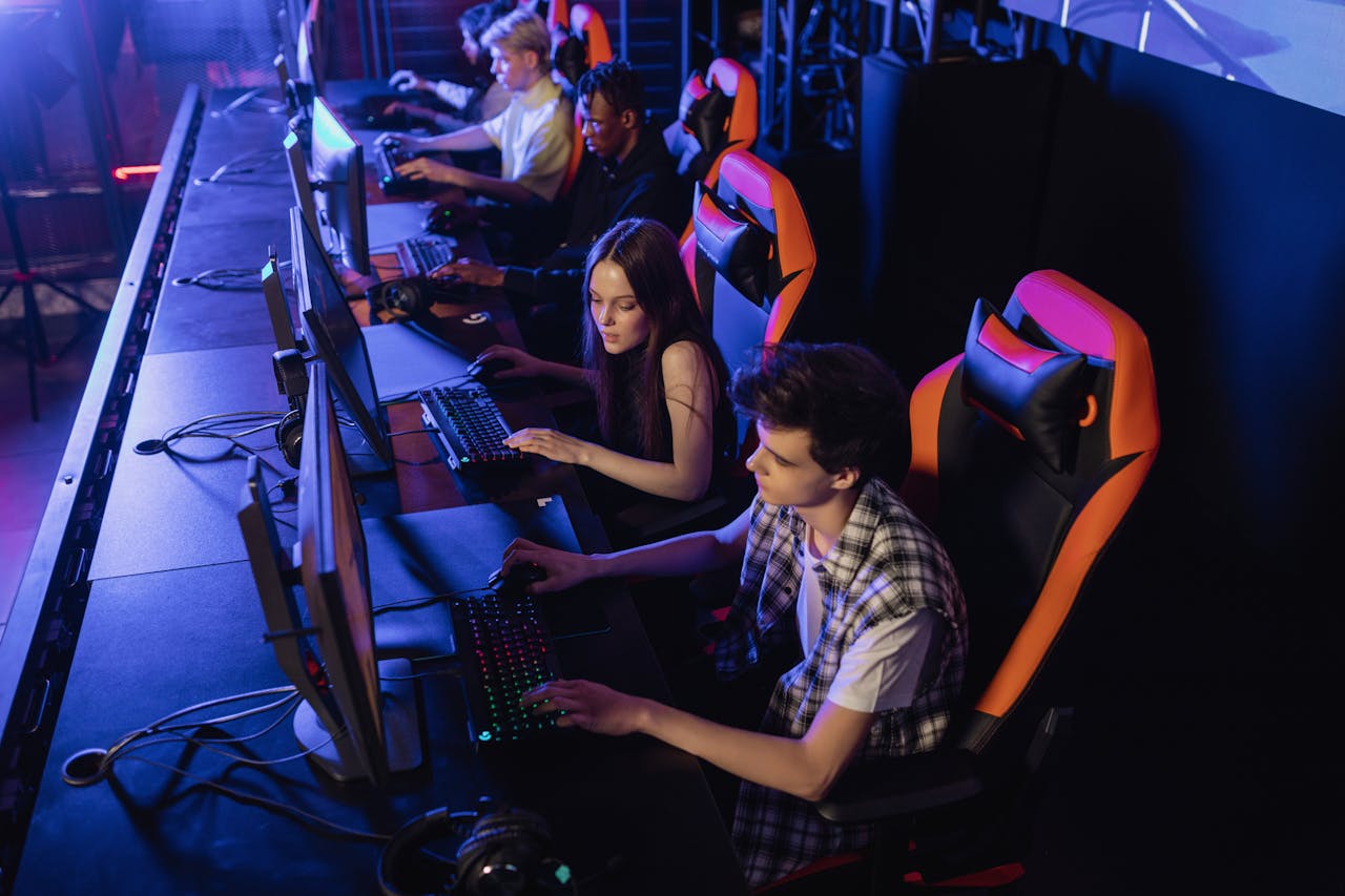 Home Teenagers engaged in a competitive gaming session at an indoor LAN event.