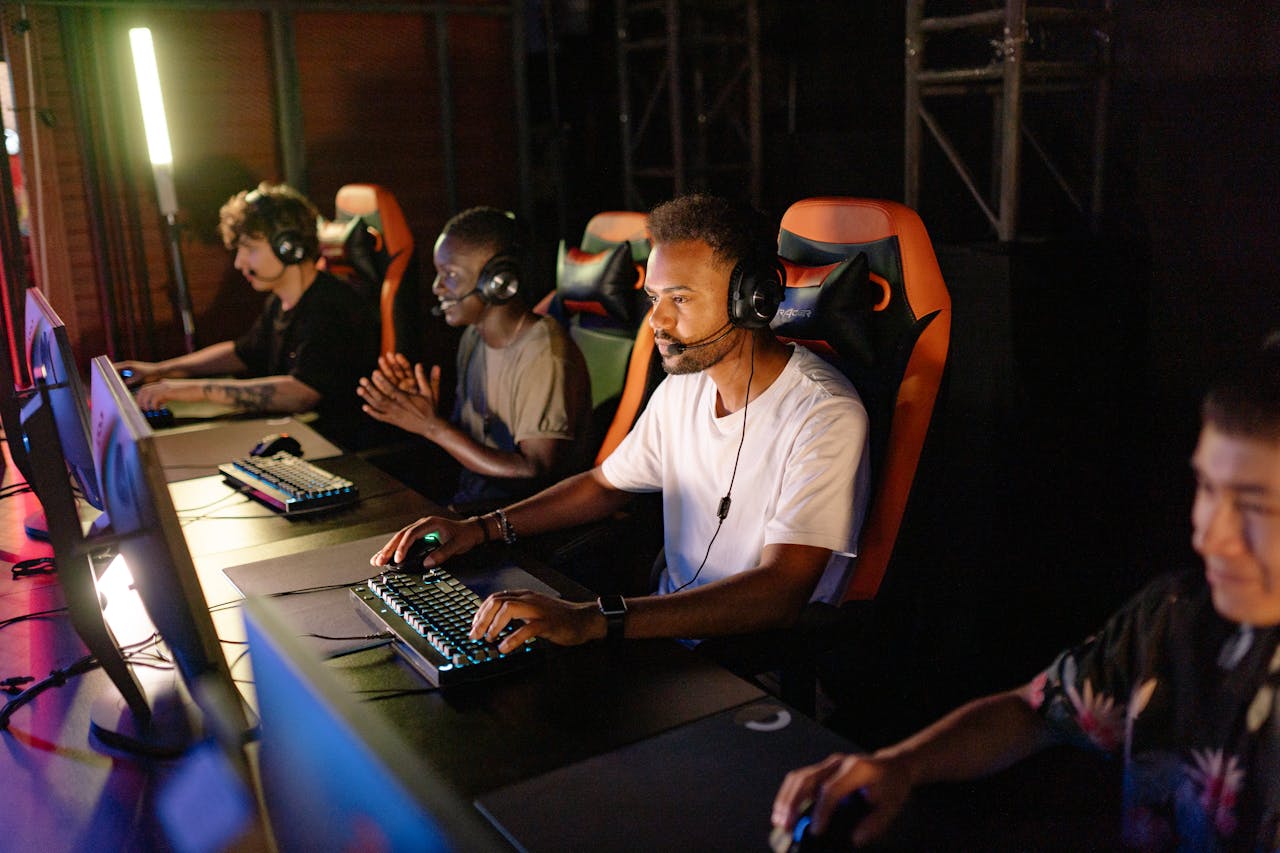 Services A group of young adults intensely focused on a competitive esports tournament indoors.